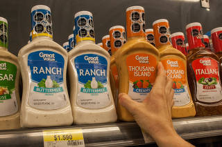 Bottles of salad dressing with warning labels denoting items high in sugar, salt, calories or saturated fat, in Santiago, Chile.
