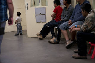 Minors sit in a processing room at a U.S. Customs and Border Protection facility in Tucson, Ariz.