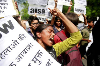 FILE PHOTO: Woman reacts at protest against rape of girl and teenager, in New Delhi