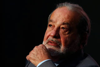Billionaire Carlos Slim look on as he listens to former New York City Mayor Michael Bloomberg during a forum in Mexico City