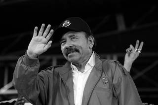 Nicaragua's President Daniel Ortega waves to supporters during celebrations to mark the 39th anniversary of the 