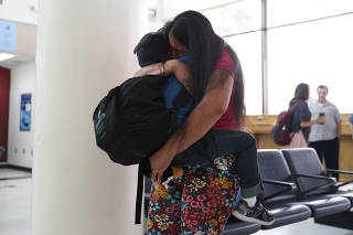 An asylum seeker from Honduras is reunited with her five-year-old son at Brownsville South Padre International Airport in Brownsville
