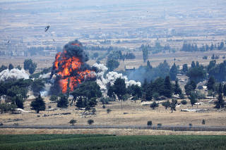 An explosion is seen at Quneitra at the Syrian side of the Israeli Syrian border as it is seen from the Israeli-occupied Golan Heights