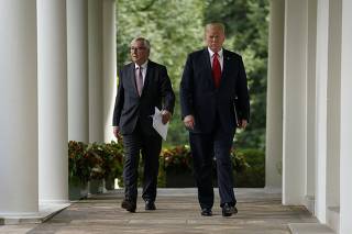 European Commission President Juncker and U.S. President Trump walk down the West Wing colonnade together at the White House in Washington