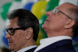 President of the Brazilian Labour Party, Roberto Jefferson reacts near Geraldo Alckmin of the Brazilian Social Democracy Party (PSDB) during a national convention of the Brazilian Labour Party, that declared support for Alckmin candidacy for the presidency