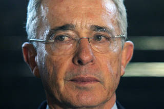 Former Colombian President Alvaro Uribe talks to the media in Rionegro