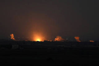 FILE PHOTO: Fire follows an explosion at the Syrian side of the Israeli Syrian border as it is seen from the Israeli-occupied Golan Heights