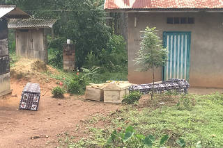 Coffins are seen outside homes near Mangina