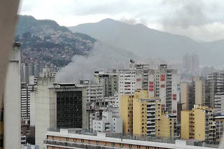 Smoke rises in Caracas