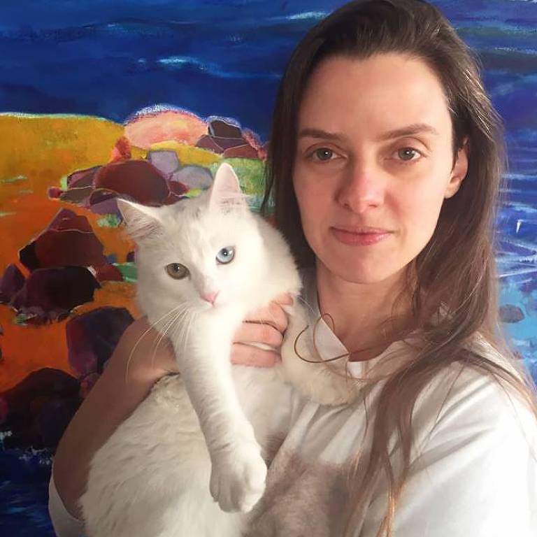 Alessandra Duarte com a gata Alma, que tem um olho amarelo e outro azul