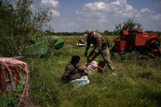 A border patrol agent apprehends men from Brazil after they illegally crossed into the U.S. border from Mexico in Los Ebanos, Texas