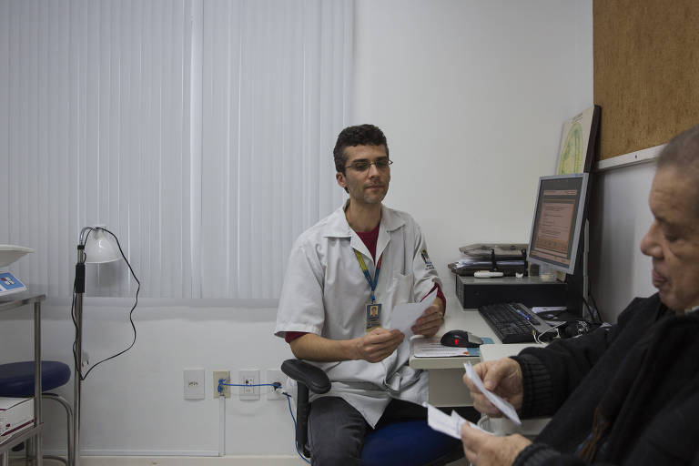 O enfermeiro Mateus da Silva Kretzer atende um paciente no Centro de Saúde Itacorubi em Florianópolis.
