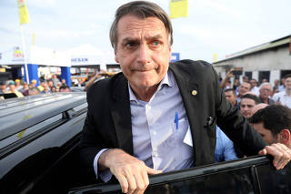 Presidential candidate Jair Bolsonaro leaves an agribusiness fair in Esteio