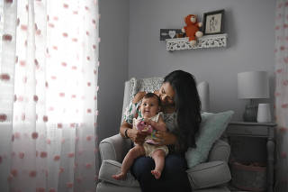 Nicole Roberts with her 5-month old daughter Amelia, at home in North Stonington, Conn.