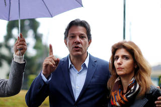 Workers Party vice presidential candidate Fernando Haddad and his wife Ana Estela leave the Federal Police headquarters, where Brazilian former President Luiz Inacio Lula da Silva is imprisoned, after visiting him, in Curitiba
