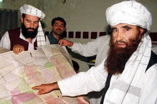 FILE PHOTO - Jalaluddin Haqqani, the Taliban's Minister for Tribal Affairs, points to a map of Afghanistan during a visit to Islamabad, Pakistan