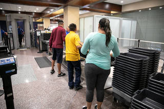 A family goes through airport security in McAllen, Texas.