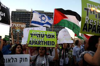 Israeli Arabs and their supporters take part in a rally to protest against Jewish nation-state law in Rabin square in Tel Aviv