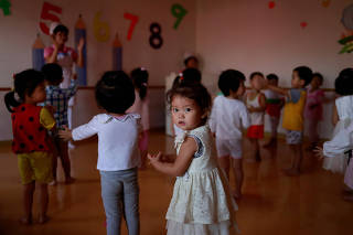 Children sing in a kindergarten and day care for employees' children at a silk factory during a government organised visit for foreign reporters ahead of the 70th anniversary of North Korea's foundation in Pyongyang