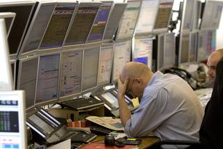 Traders work at the French brokerage Global Equities office in Paris