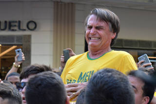 Brazilian presidential candidate Jair Bolsonaro reacts after being stabbed during a rally in Juiz de Fora