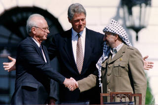 FILE PHOTO: PLO Chairman Arafat shakes hands with Israeli PM Rabin after the signing of the Israeli-PLO peace accord, in Washington