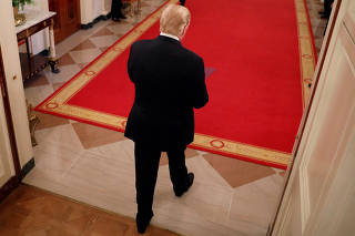 U.S. President Donald Trump leaves after delivering remarks at a reception for Congressional Medal of Honor recipients in the East Room of the White House in Washington, U.S.