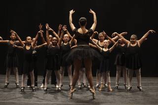 Brazilian dancer Roberta Marquez of The Royal Ballet demonstrates a movement to students after a masterclass with dancers of the Royal Opera House at the Rio de Janeiro Municipal Theatre