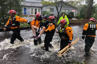 Search and Rescue workers from New York rescue a man from flooding caused by Hurricane Florence in River Bend
