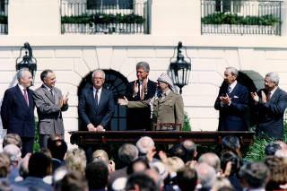 FILE PHOTO: PLO Chairman Arafat gestures to Israeli PM Rabin after the signing of the Israeli-PLO peace accord, in Washington