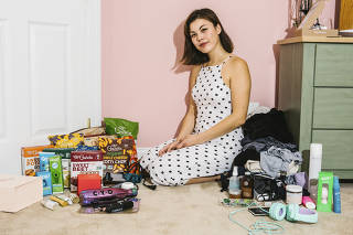 Annabelle Schmitt in her bedroom among some of the many products she is asked to feature on her Instagram feed, in Kennett Square, Pa.