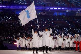 FILE PHOTO: Hwang Chung Gum and Won Yunjong of Korea carry a unified Korea flag in opening ceremony of Pyeongchang Winter Olympics, South Korea, Feb 9 2018
