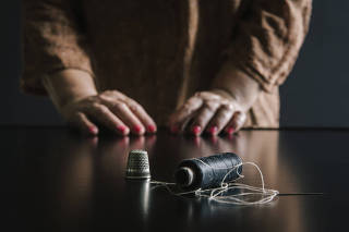 A sewing thimble and a black thread spool used for the fall fashion collections, in the Puglia region of Italy.