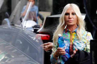 Italian designer Donatella Versace arrives to meet employees in Milan