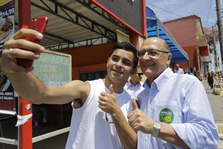 O candidato à Presidência pelo PSDB Geraldo Alckmin tira selfie com eleitor durante caminhada pelo bairro de Perus, zona norte de São Paulo
