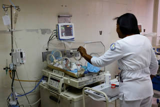 Carolina Urbina checks a premature baby in an incubator at the Concepcion Palacios Hospital in Caracas