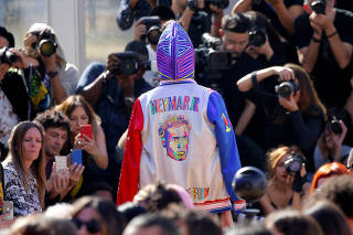 A model presents a creation with a portrait of PSG soccer player Neymar by Indian designer Manish Arora as part of his Spring/Summer 2019 women's ready-to-wear collection show during Paris Fashion Week
