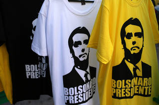 T-shirts depicting Jair Bolsonaro, far-right lawmaker and presidential candidate of the Social Liberal Party (PSL) are seen in front of the Bolsonaro's condominium at Barra da Tijuca neighborhood in Rio de Janeiro