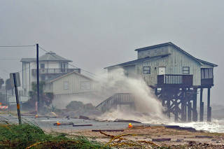 Waves crash on stilt houses along the shore due to Hurricane Michael at Alligator Point in Franklin County