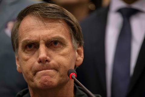 Brazil's right-wing presidential candidate for the Social Liberal Party (PSL) Jair Bolsonaro gestures during a press conference in Rio de Janeiro, Brazil on October 11, 2018. - The far-right frontrunner to be Brazil's next president, Jair Bolsonaro, stumbled Wednesday by spooking previously supportive investors, while a spate of violent incidents pointed to deep polarization caused by the election race. (Photo by Mauro Pimentel / AFP)