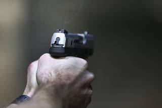 A man fires a Taurus Millennium 9mm at the Ringmasters of Utah gun range