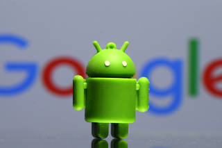 FILE PHOTO: A 3D printed Android mascot in front of a Google logo