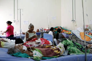 Patients are seen on beds inside a public hospital in Boa Vista