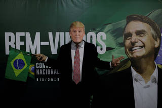 FILE PHOTO: A supporter of Federal deputy Bolsonaro wears a mask of U.S President Trump before the national convention of  the Social Liberal Party (PSL) where he is to be formalised as a candidate for the Presidency of the Republic, in Rio de Janeiro