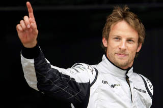 Brawn GP driver Jenson Button waves after qualifying in pole position for the Spanish F1 Grand Prix at the Catalunya racetrack in Montmelo