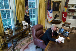 President Donald Trump speaks by phone with the prime minister of Ireland, in the Oval Office of the White House in Washington.