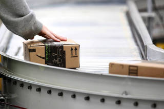 Employees work at the Amazon fulfillment center in Kent