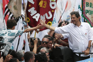 Fernando Haddad, presidential candidate of Brazil's leftist Workers Party (PT), and his wife Ana Estela attend a march for peace at Heliopolis slum in Sao Paulo