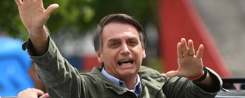 Jair Bolsonaro, far-right lawmaker and presidential candidate for the Social Liberal Party (PSL), gives thumbs up to supporters, during the second round of the presidential elections, in Rio de Janeiro, Brazil on October 28, 2018. - Brazilians will choose their president today during the second round of the national elections between the far-right firebrand Jair Bolsonaro and leftist Fernando Haddad (Photo by MAURO PIMENTEL / AFP) ORG XMIT: AGEN1810281004177750