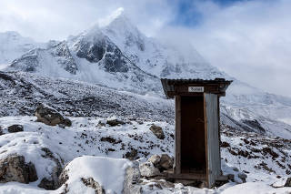 Outdoor toilet in Himalayas mountains. Unusual and funny outdoor toilet location in snowy mountains on Everest Base Camp Trek. Portal or escape from cold winter to hot summer.